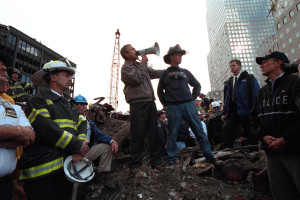 Standing atop rubble with retired New York City firefighter Bob Beckwith Friday, Sept. 14, 2001, President George W. Bush rallies firefighters and rescue workers during an impromptu speech at the site of the collapsed World Trade Center in New York City. Photo by Eric Draper, Courtesy of the George W. Bush Presidential Library