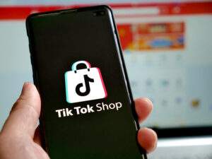 Tenggarong, November, 2023. Smart phone with tik tok shop logo on it, e-commerce social media commerce concept