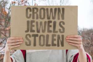 Cardboard sign with "CROWN JEWELS STOLEN" written